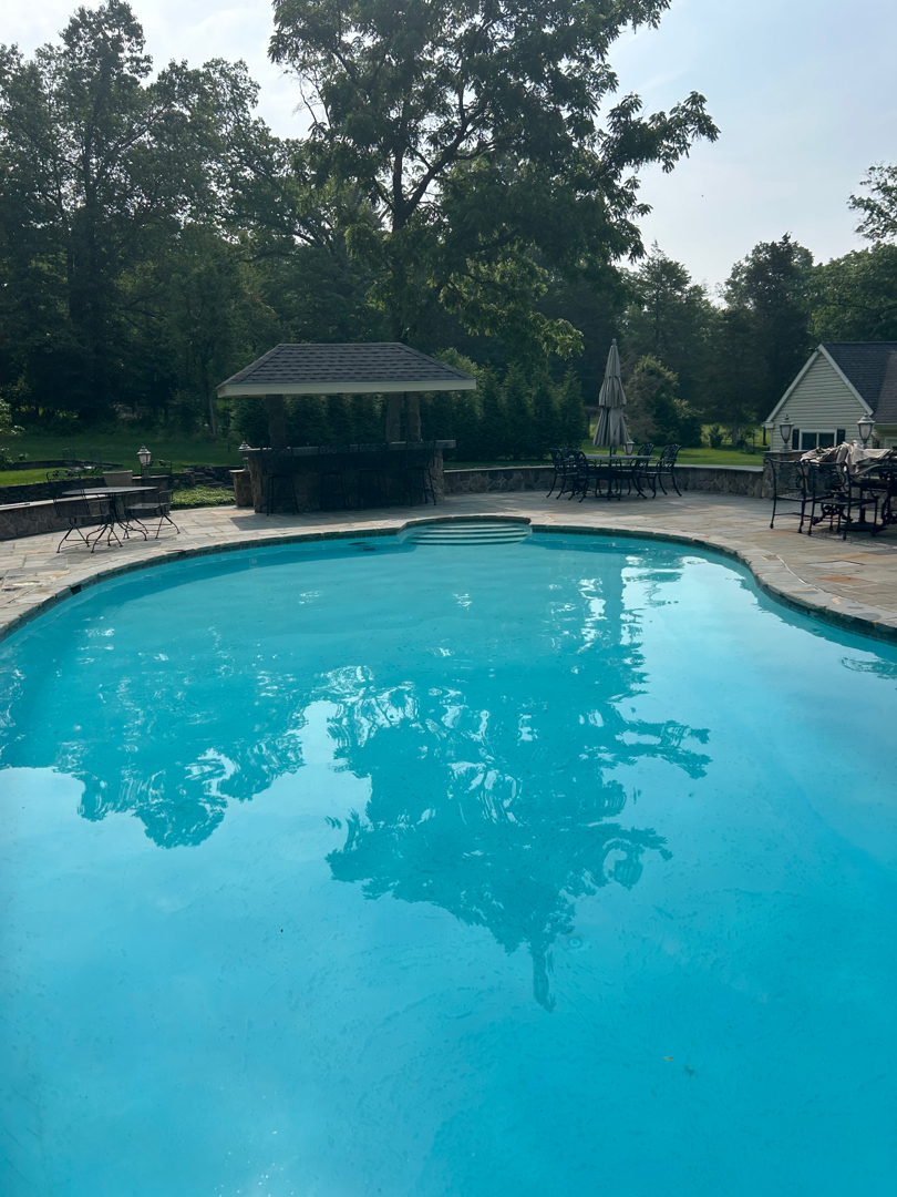 beautiful pool, clean and blue in Furlong PA cleaned weekly by Merman Swimming Pool Services in Doylestown PA